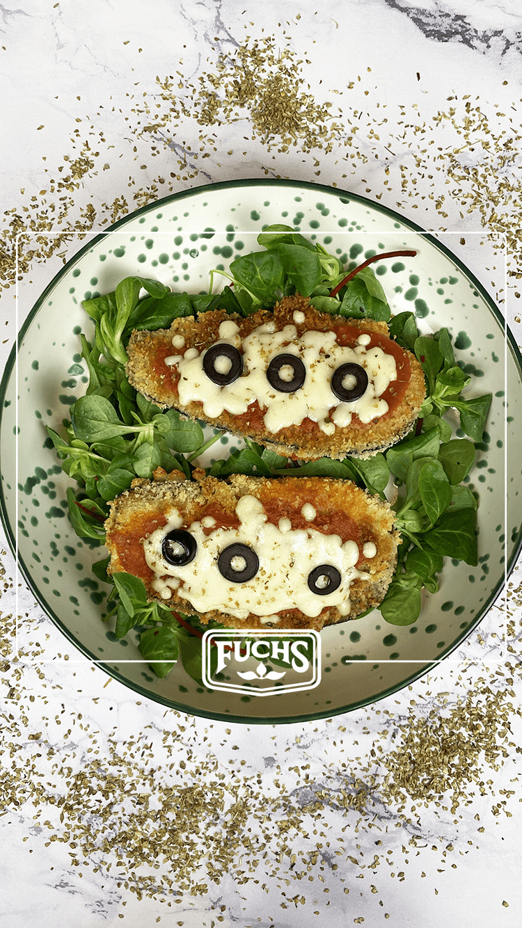 Tranches d'aubergines panées dorées gratinées au four façon pizza avec de la sauce tomate, mozzarella, olives noires et origan Fuchs